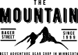 A green background with black lettering and a mountain.